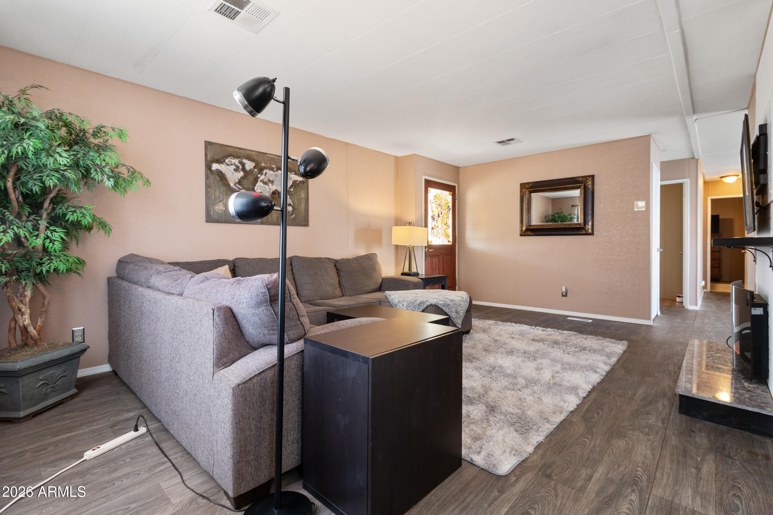 535 South Alma School Road, Unit 99 Mesa, AZ 85210 - Photo 7 of 77 a living room with furniture and a potted plant
