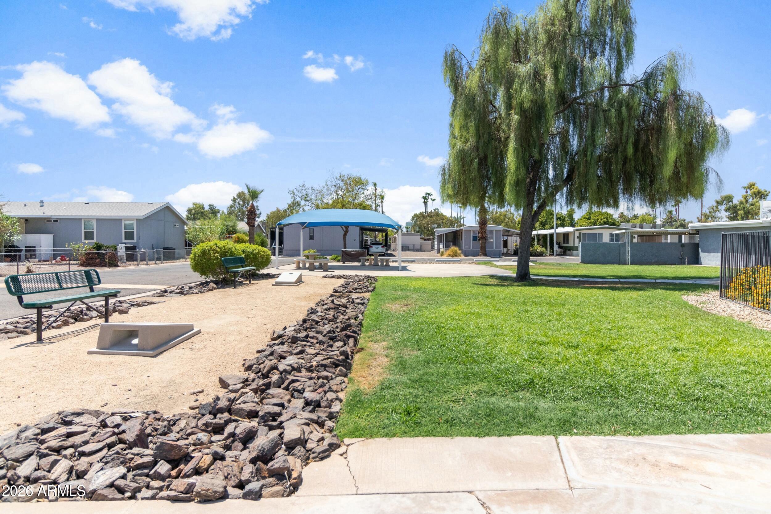 535 South Alma School Road, Unit 99 Mesa, AZ 85210 - Photo 75 of 77 a swimming pool with outdoor seating and yard