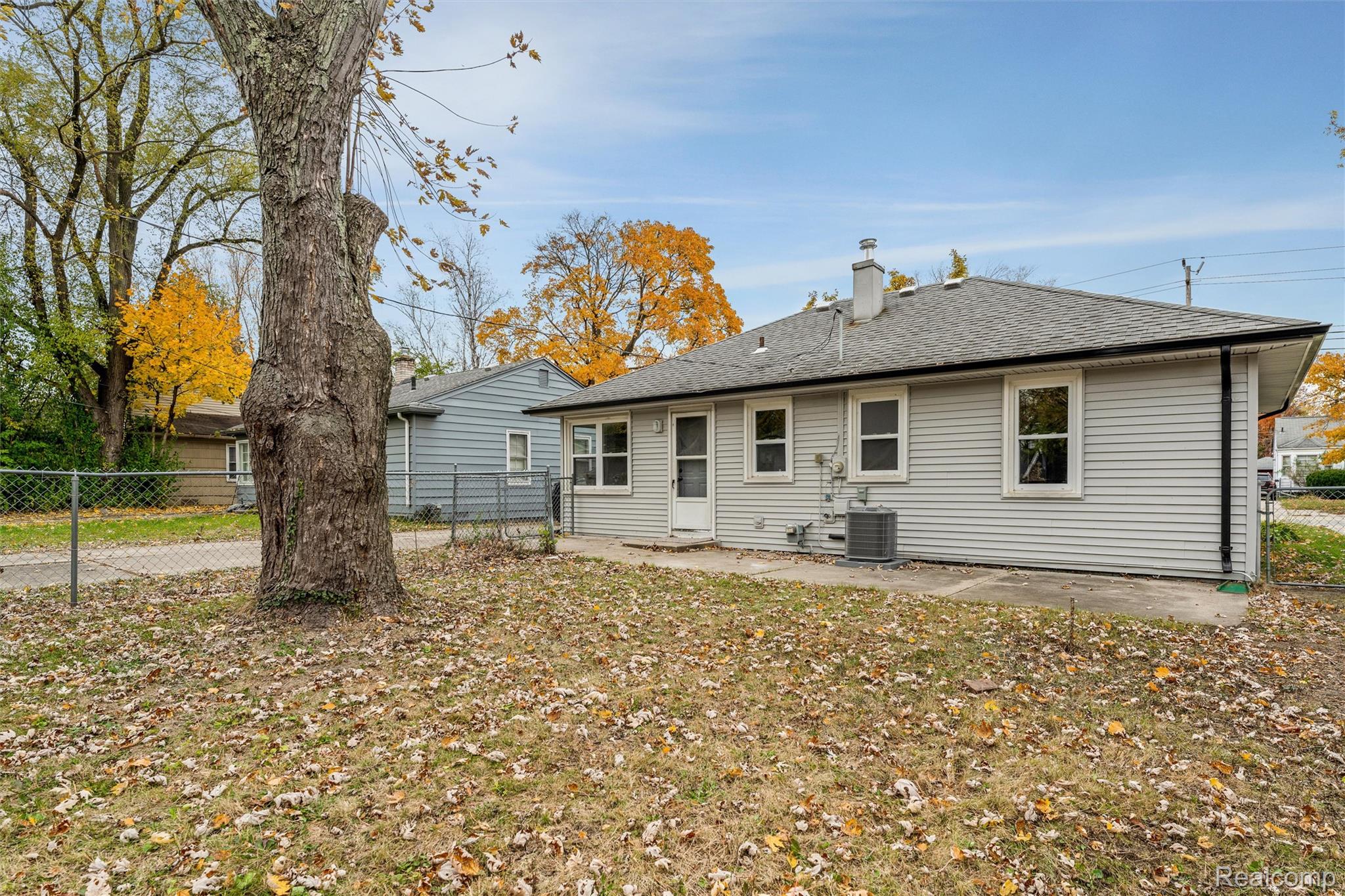 15751 West 14 Mile Road Franklin, MI 48025 - Photo 21 of 24 Rear exterior with light gray horizontal siding and a gray shingle roof