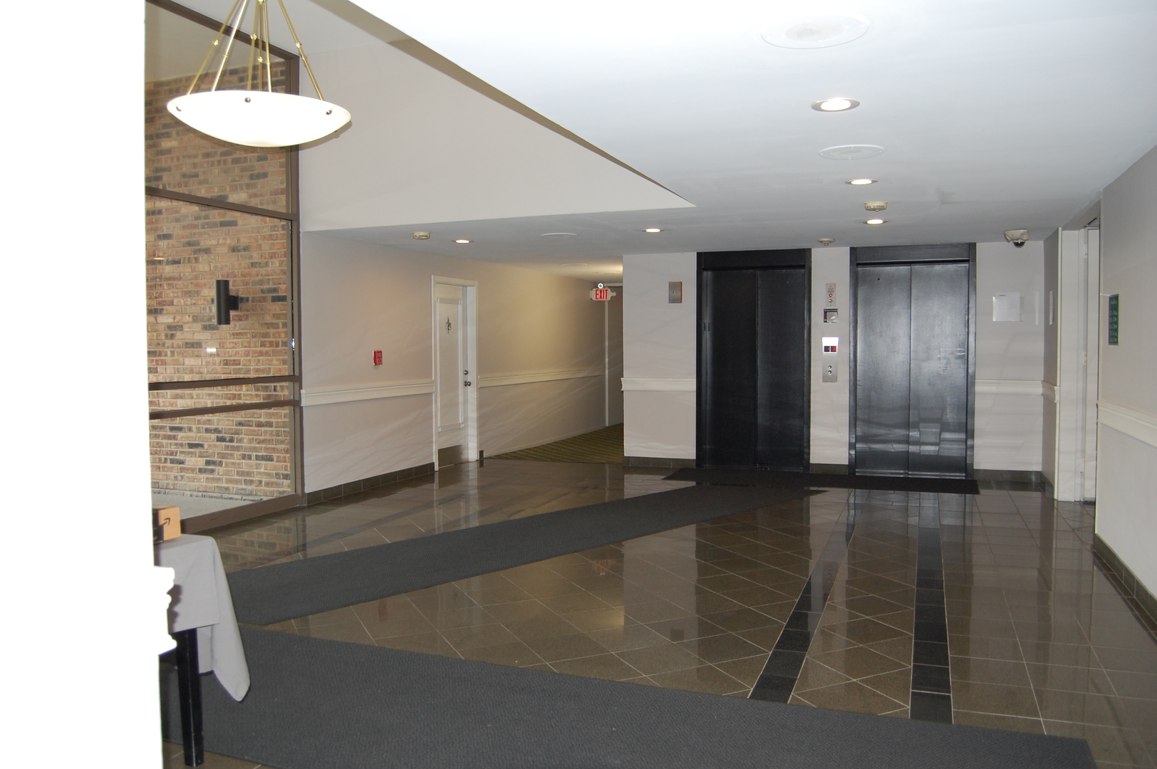 1919 Prairie Square, Unit 102 Schaumburg, IL 60173 - Photo 17 of 25 a view of a hallway with wooden floor
