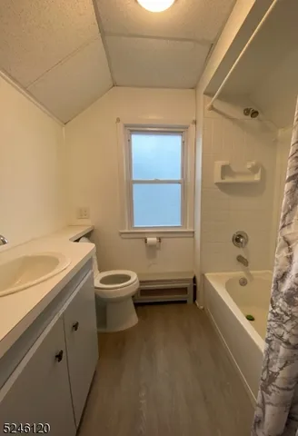 a bathroom with a granite countertop sink a toilet and bathtub