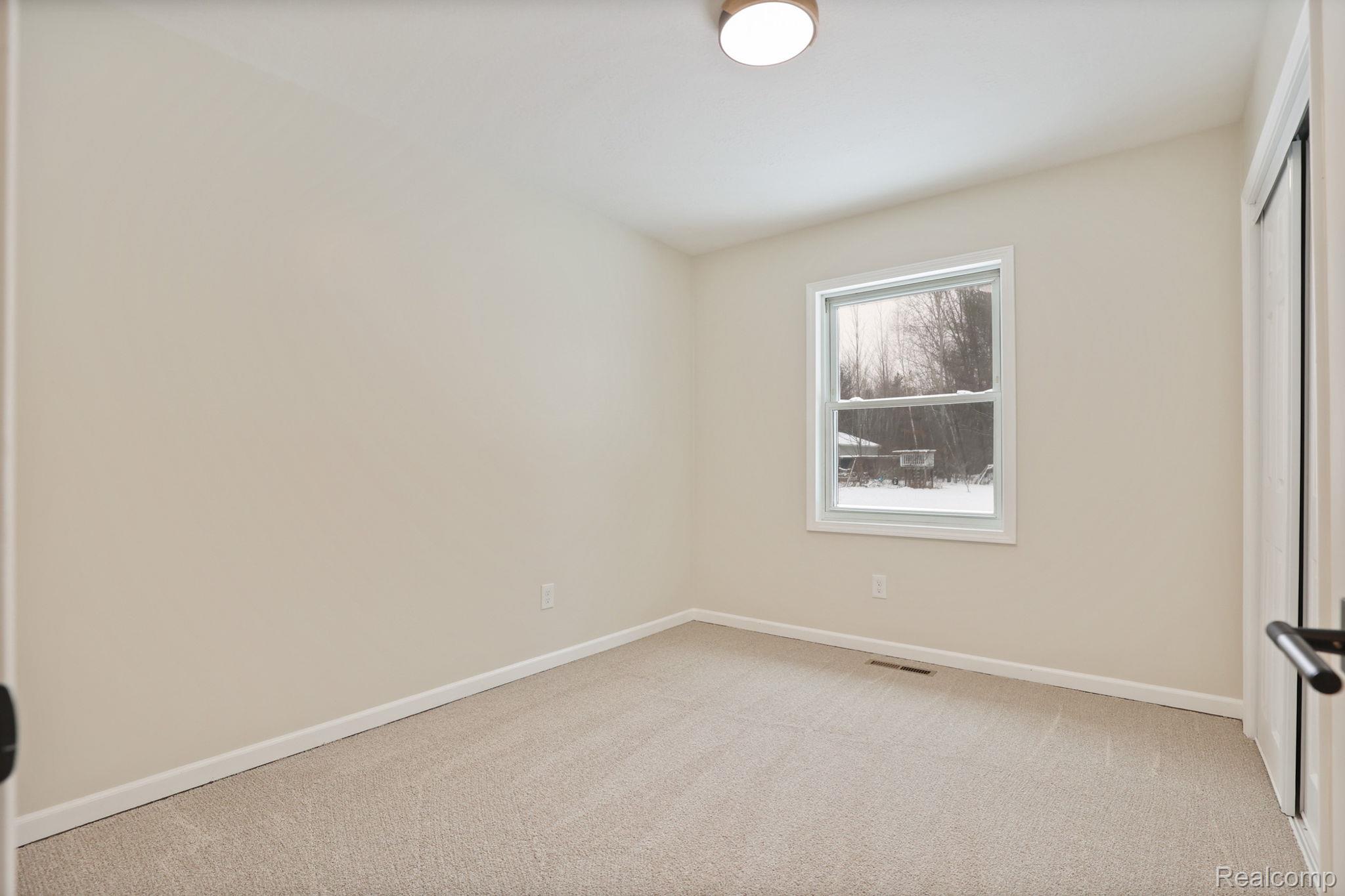 3937 Curtis Road Birch Run, MI 48415 - Photo 21 of 33 Unfurnished bedroom with light carpet and baseboards