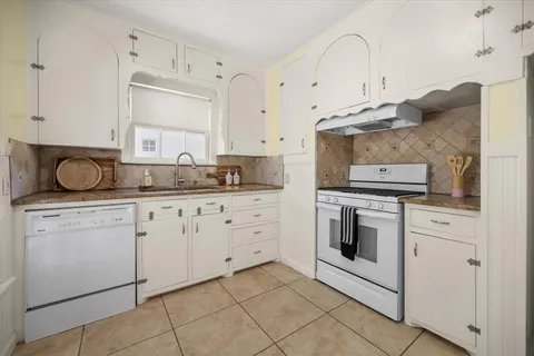 a kitchen with cabinets stainless steel appliances and a sink