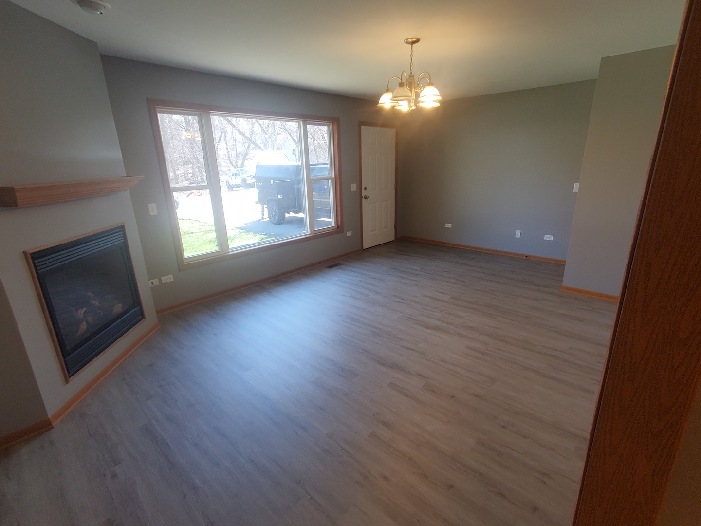 38188 North 3rd Avenue Spring Grove, IL 60081 - Photo 3 of 14 an empty room with wooden floor fireplace and windows