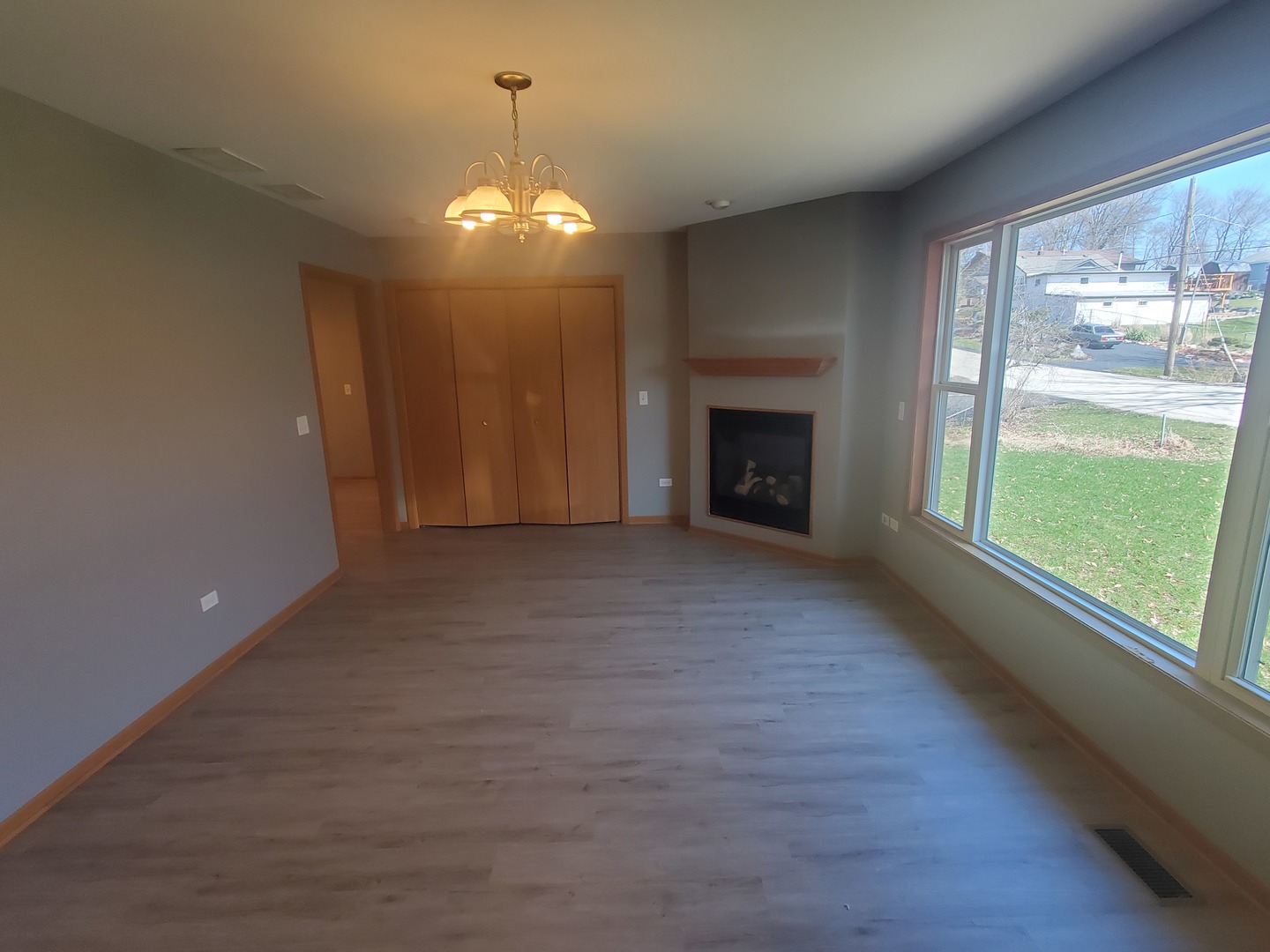 38188 North 3rd Avenue Spring Grove, IL 60081 - Photo 4 of 14 an empty room with wooden floor fireplace and windows