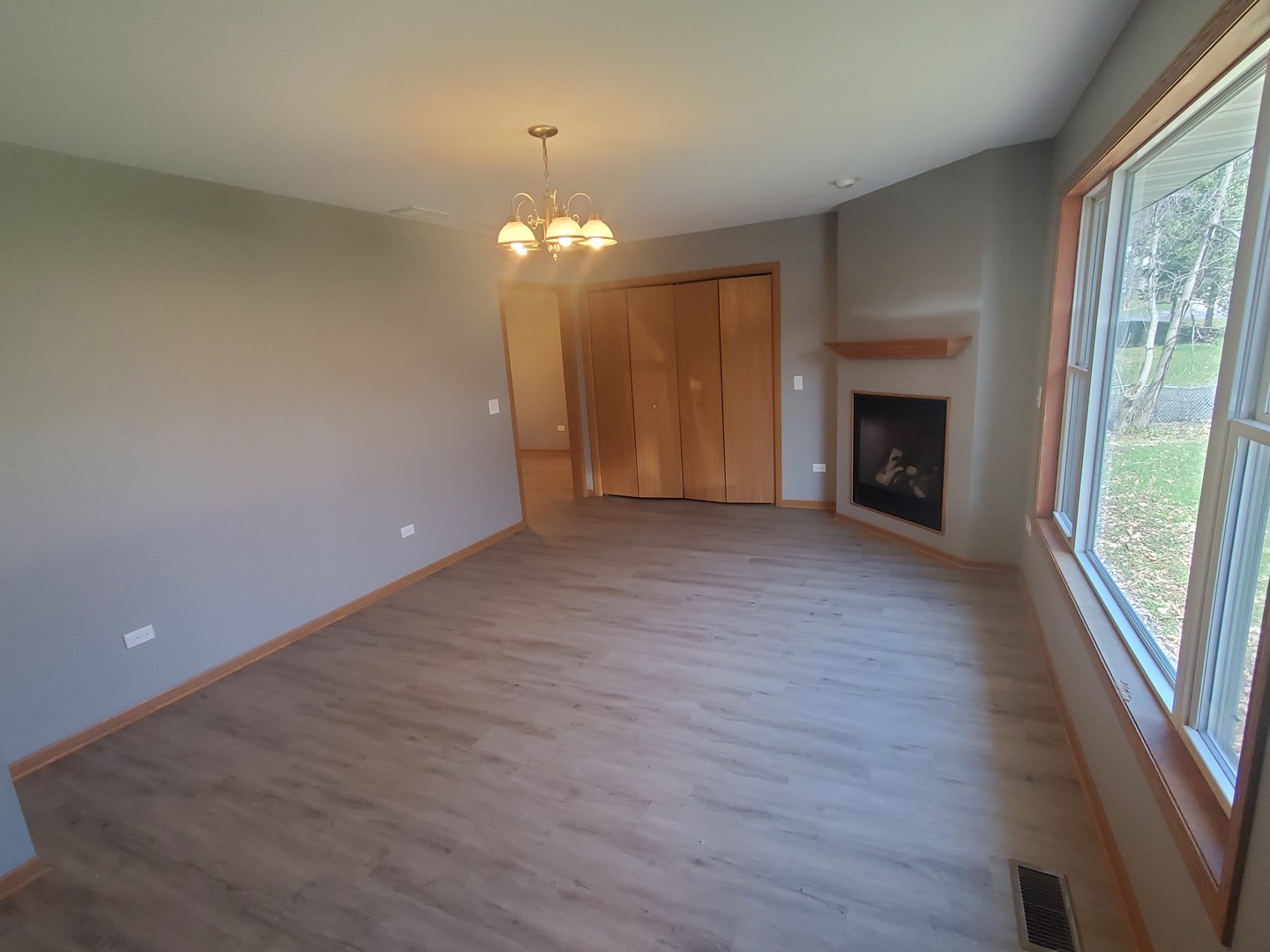 38188 North 3rd Avenue Spring Grove, IL 60081 - Photo 5 of 14 an empty room with wooden floor fireplace and windows