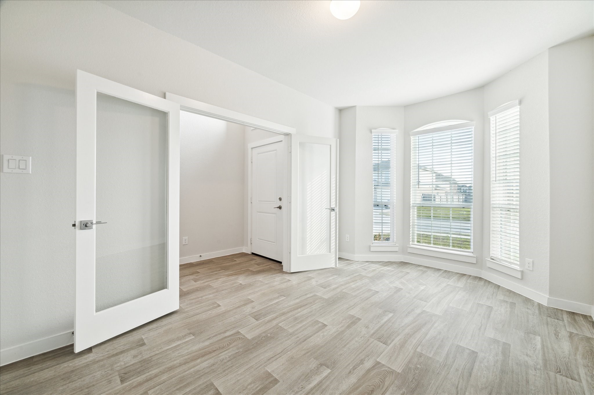 7838 Ruth Ravine Court Spring, TX 77379 - Photo 4 of 20 a view of an empty room with wooden floor and a window