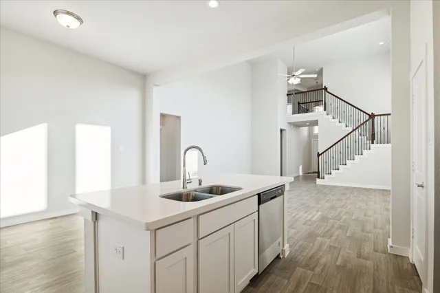 a kitchen with sink cabinets and wooden floor