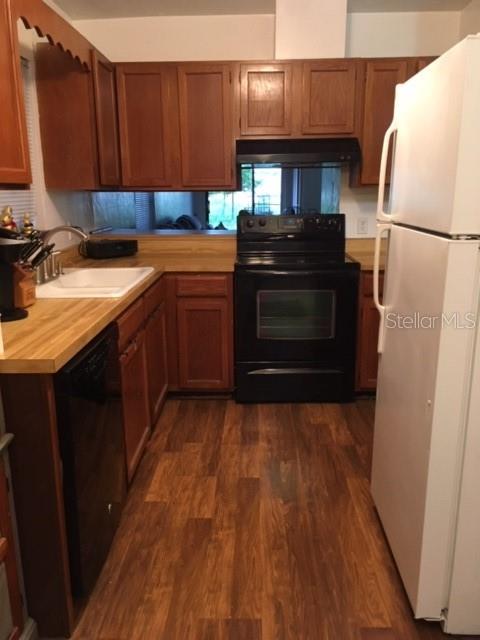 1712 Southwest 67th Terrace Gainesville, FL 32607 - Photo 3 of 10 a kitchen with a sink and a refrigerator