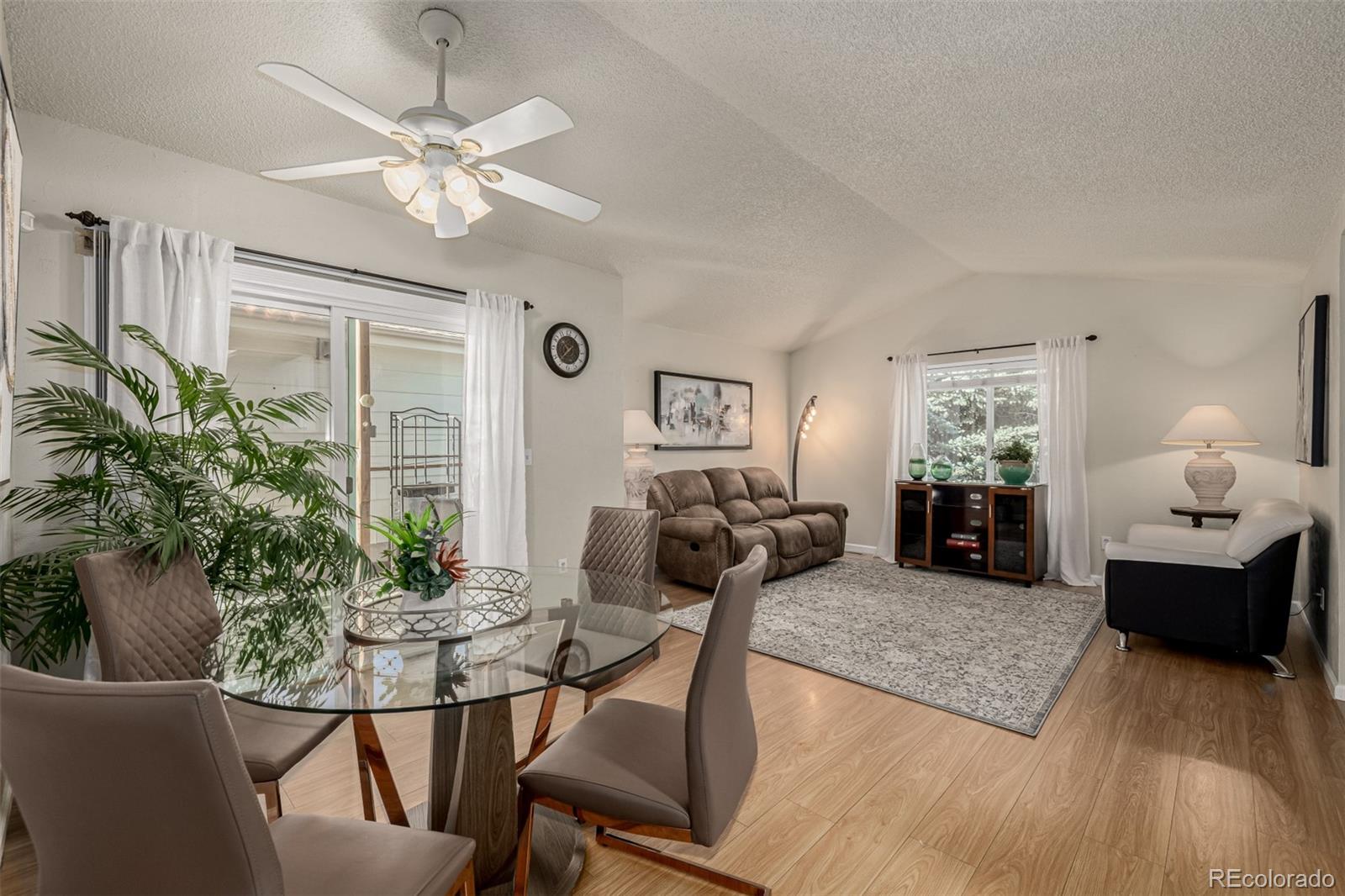 7624 Gray Way Arvada, CO 80003 - Photo 12 of 39 a living room with furniture and a chandelier