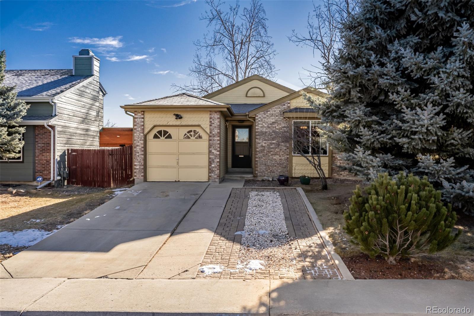 7624 Gray Way Arvada, CO 80003 - Photo 2 of 39 a front view of a house with a yard