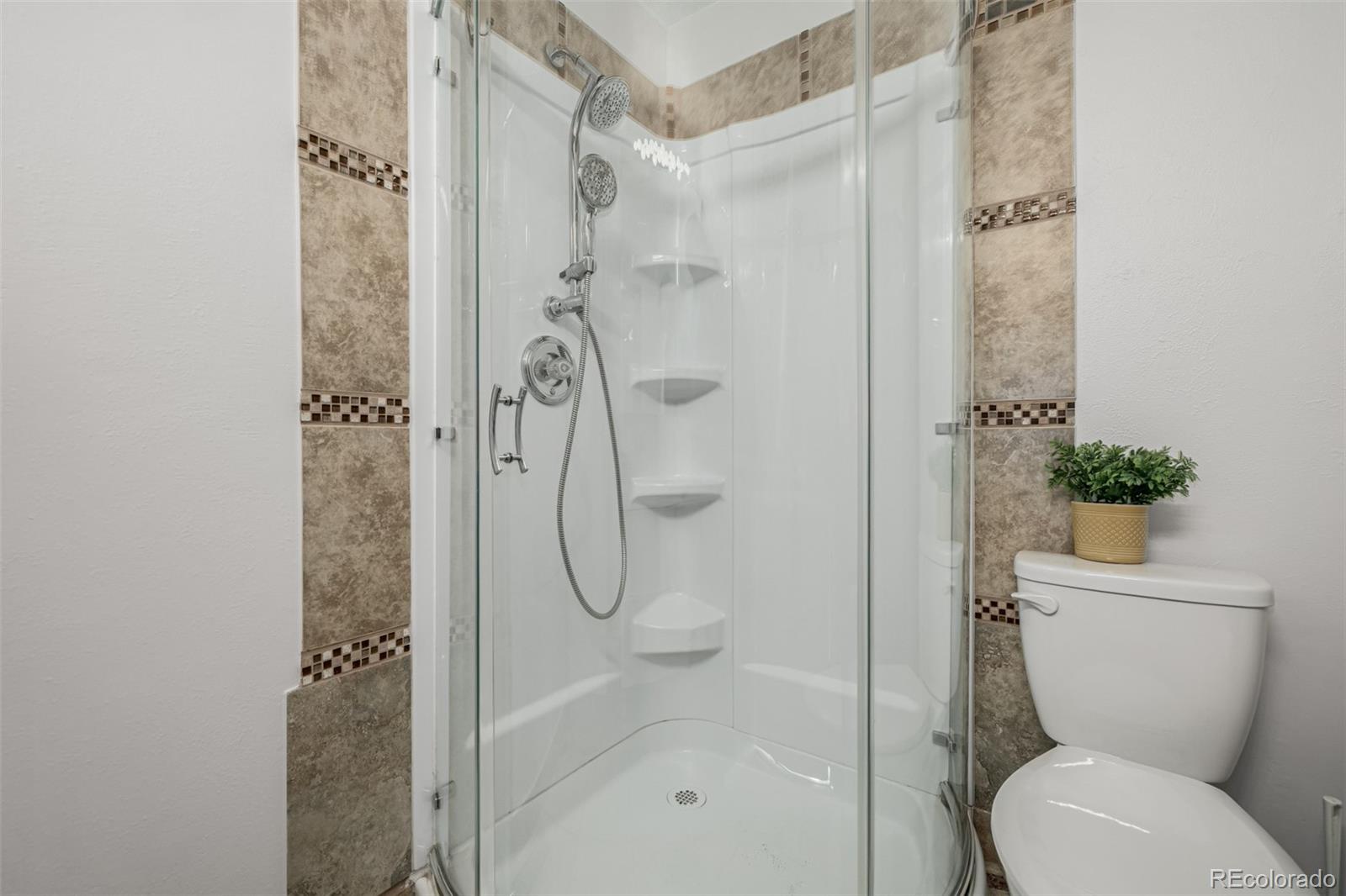 7624 Gray Way Arvada, CO 80003 - Photo 21 of 39 a bathroom with a toilet and a shower