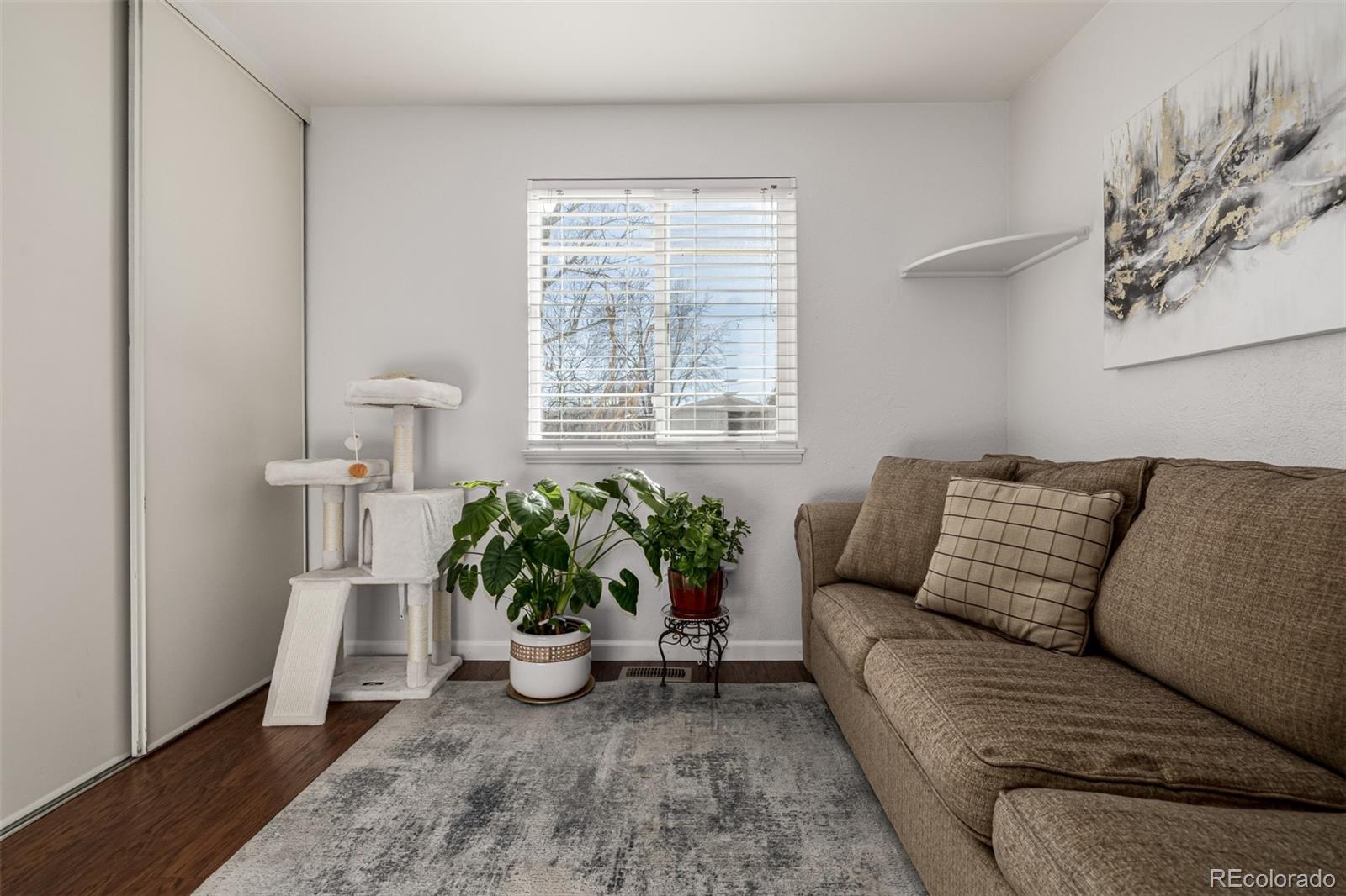 7624 Gray Way Arvada, CO 80003 - Photo 25 of 39 a living room with furniture and a potted plant