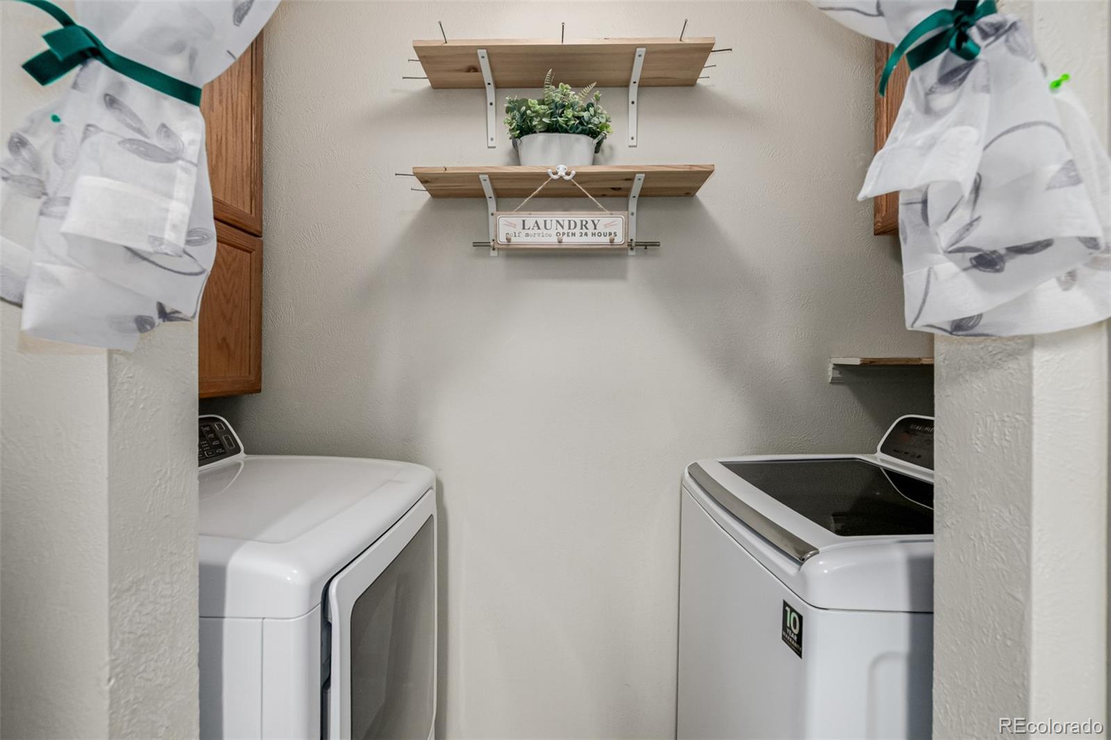 7624 Gray Way Arvada, CO 80003 - Photo 27 of 39 a utility room with dryer and washer