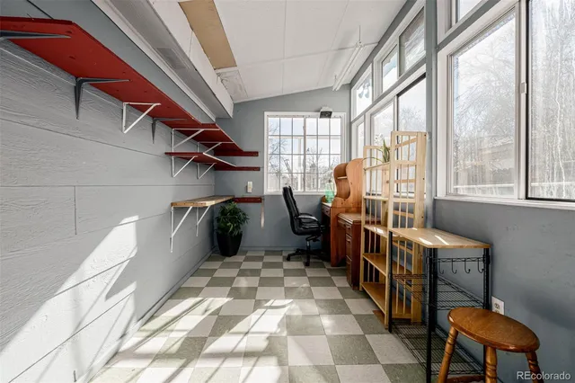 a view of a porch with a table and chairs