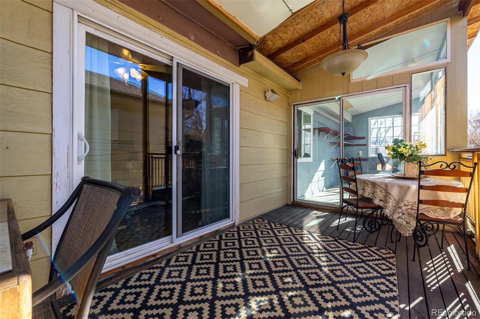 7624 Gray Way Arvada, CO 80003 - Photo 30 of 39 a view of a porch with a table and chairs