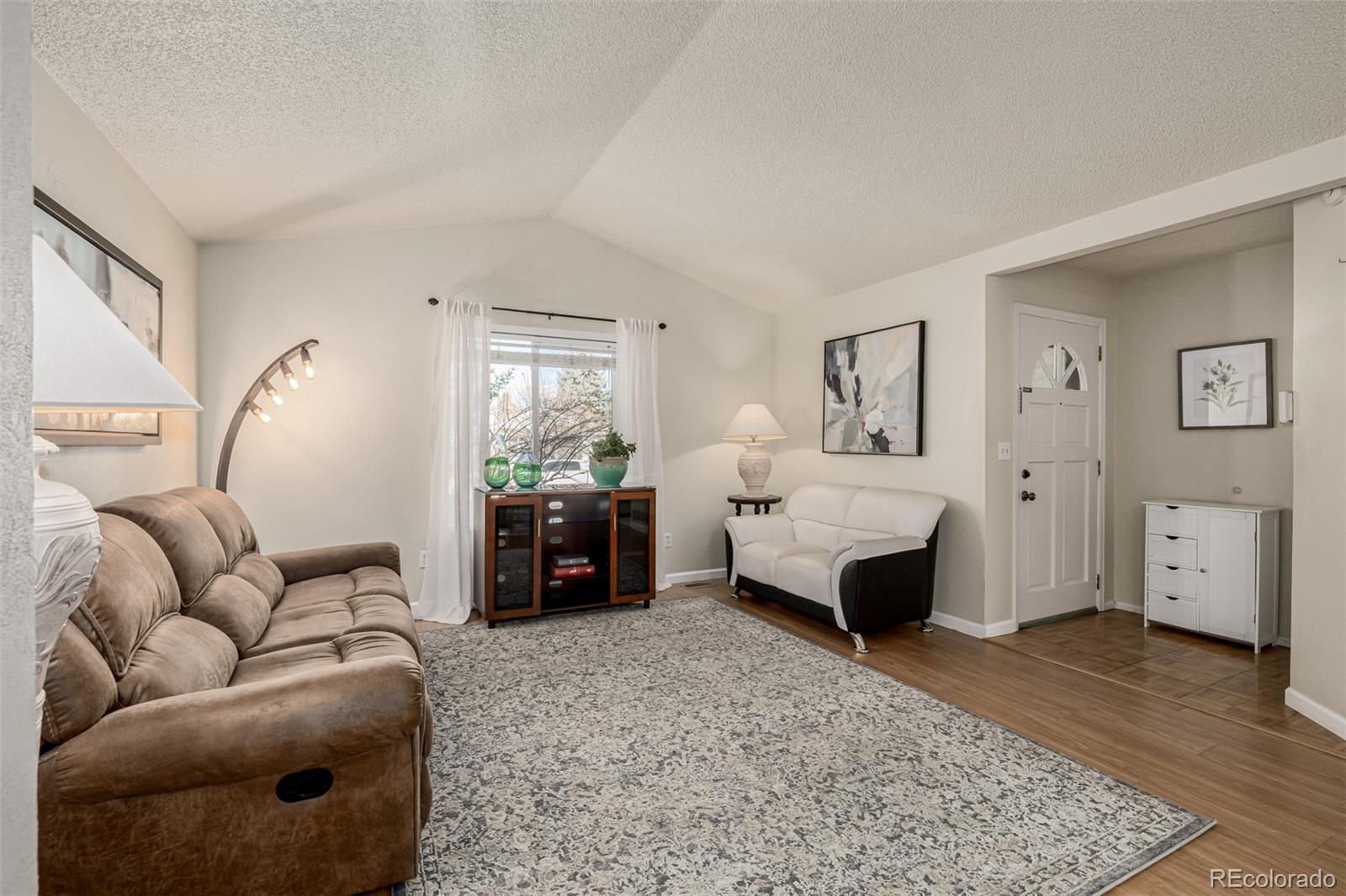 7624 Gray Way Arvada, CO 80003 - Photo 5 of 39 a living room with furniture and wooden floor