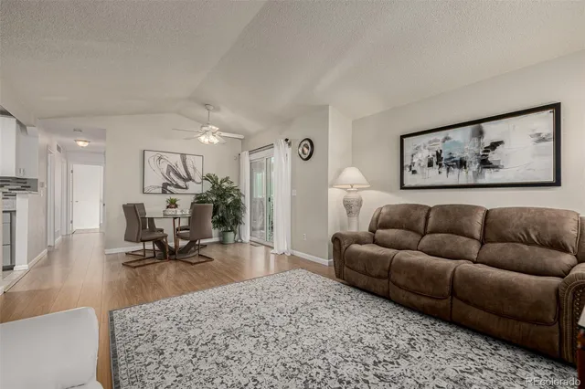 a view of a hallway with entryway and wooden floor