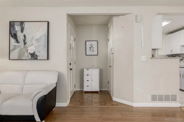 a view of a livingroom with furniture and a kitchen