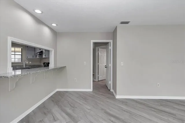 a view of a room with wooden floor and cabinet