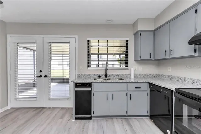 a kitchen with a sink stove and cabinets