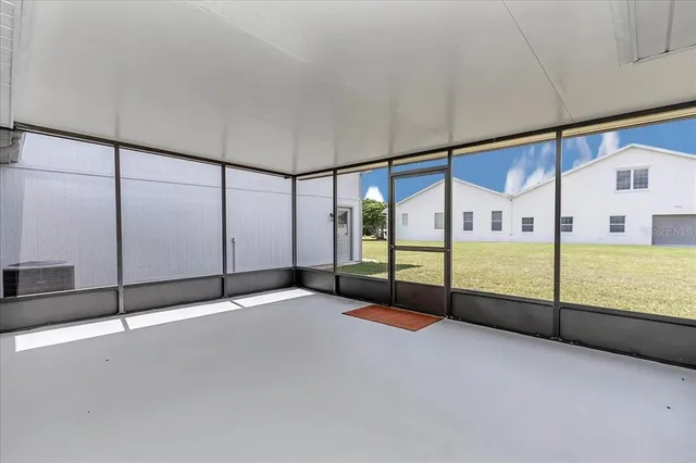 a view of an empty room with windows