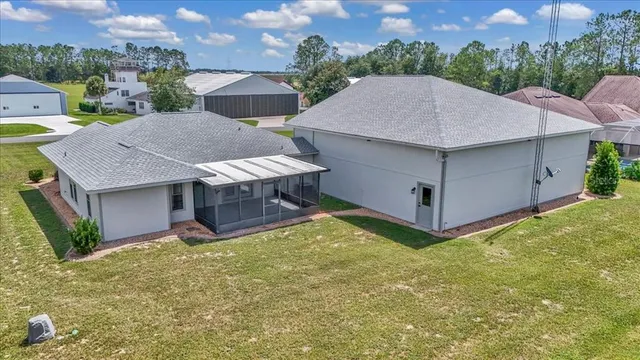 an aerial view of a house with garden space and lake view