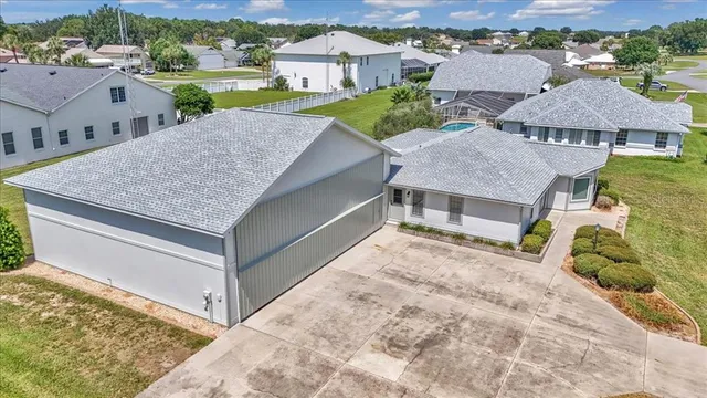 an aerial view of residential houses with outdoor space and street view