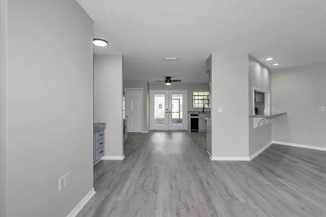 a view of a hallway with wooden floor