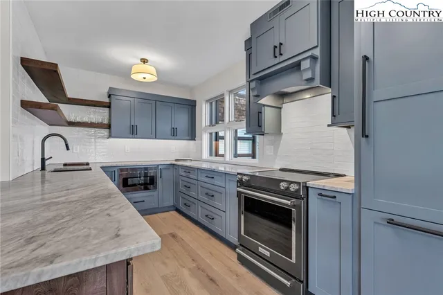 a kitchen with granite countertop a stove and a sink