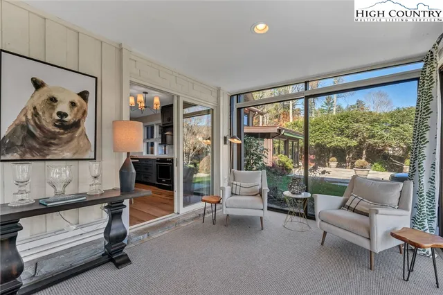 a living room with furniture and a floor to ceiling window