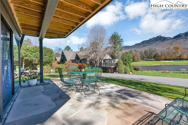 a view of a patio with a table chairs and a backyard