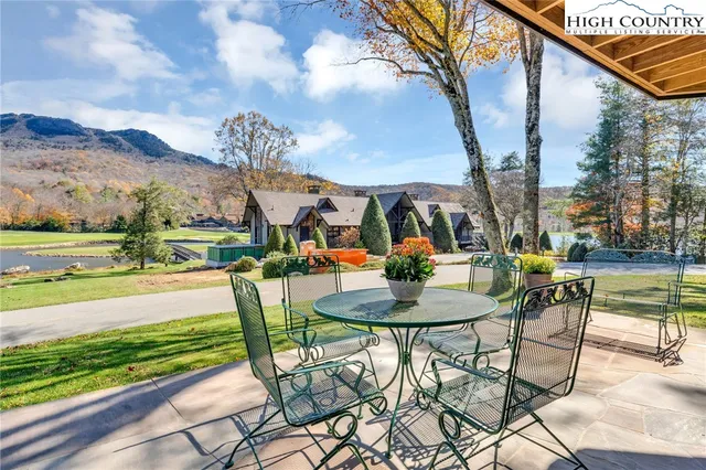 a view of swimming pool with a table and chairs