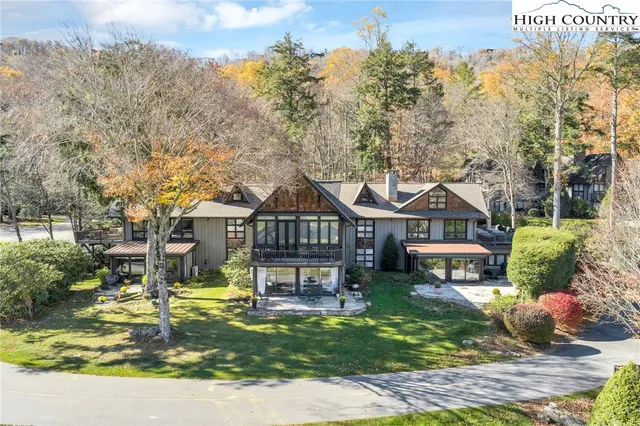 a front view of a house with a yard table and chairs