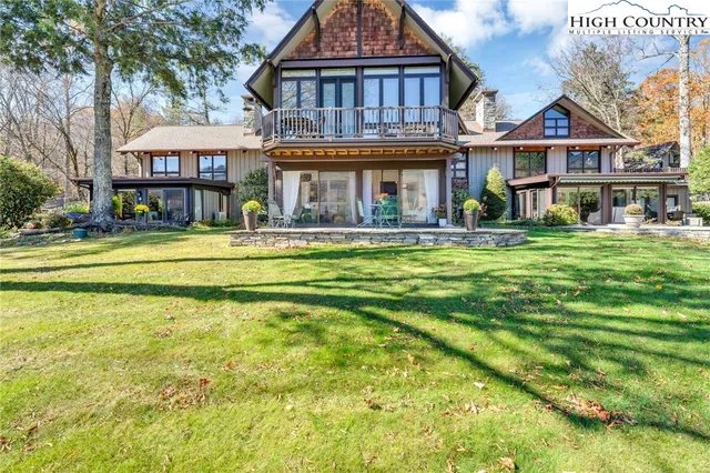 a front view of a residential houses with yard and swimming pool