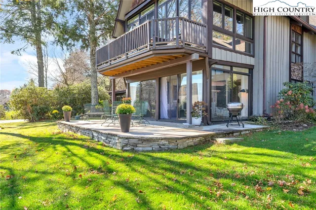 a view of a house with swimming pool and sitting area