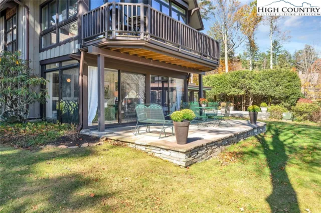 a view of a building with sitting area and garden