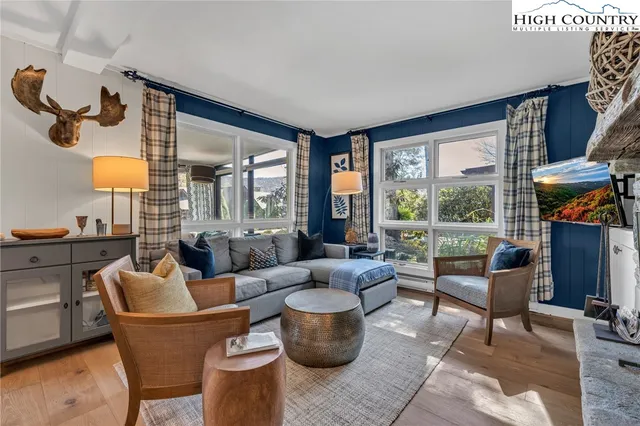 a living room with furniture and a floor to ceiling window