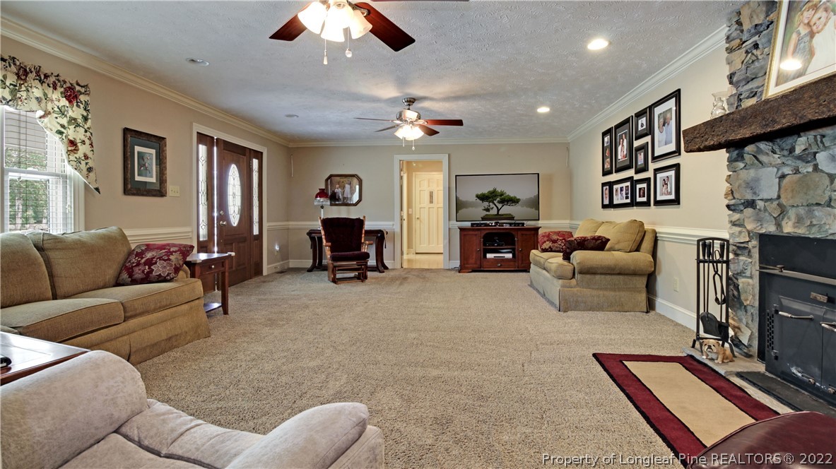 6250 Smithfield Road Wade, NC 28395 - Photo 11 of 46 a living room with furniture and a flat screen tv