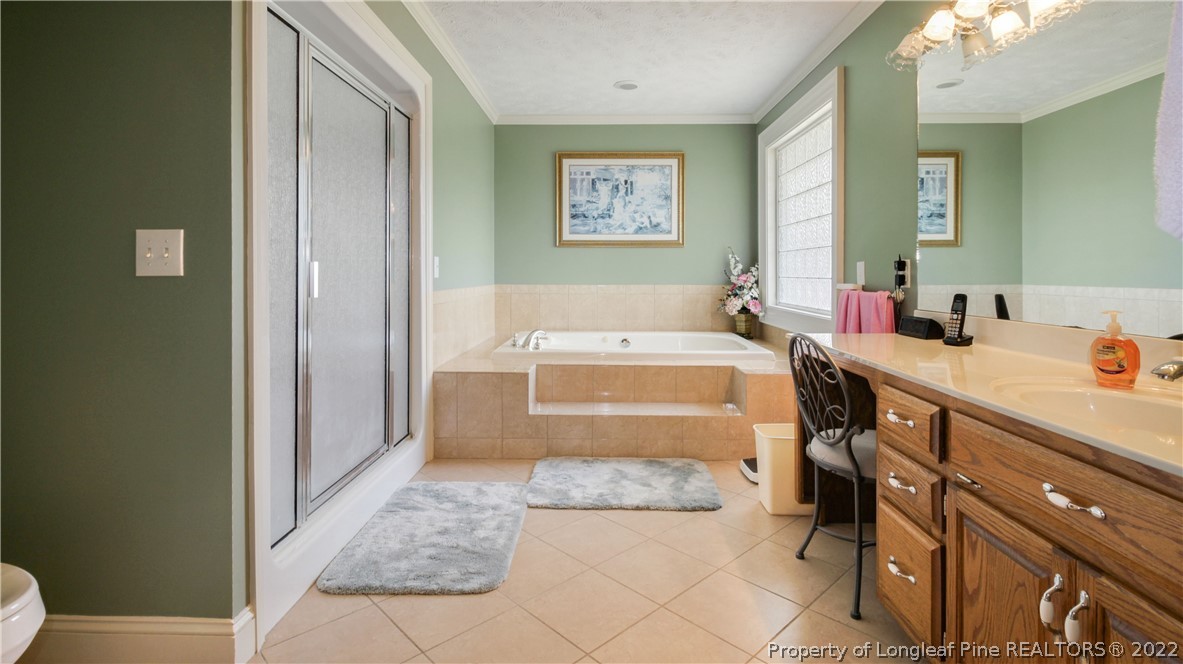 6250 Smithfield Road Wade, NC 28395 - Photo 23 of 46 a bathroom with a tub sink and mirror