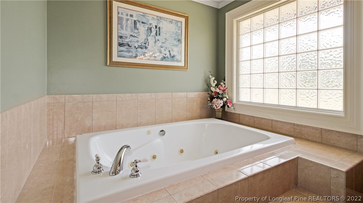 6250 Smithfield Road Wade, NC 28395 - Photo 25 of 46 a bathroom with a bathtub and a window