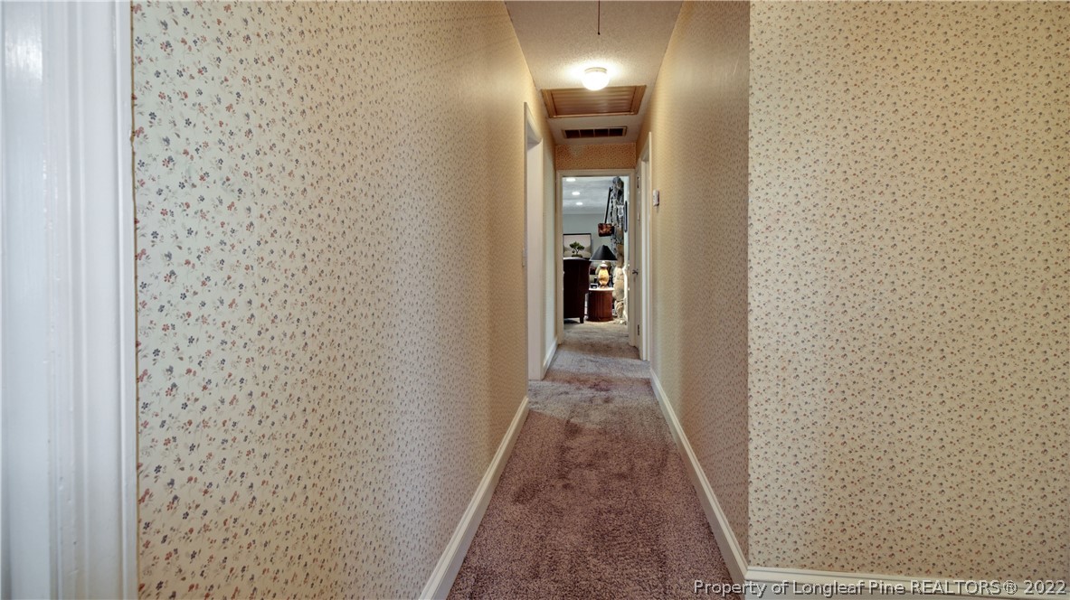 6250 Smithfield Road Wade, NC 28395 - Photo 33 of 46 a view of a hallway with wooden floor