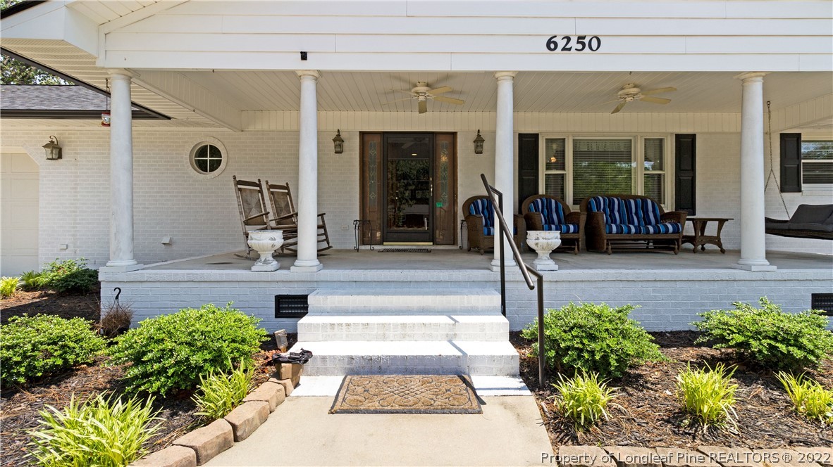 6250 Smithfield Road Wade, NC 28395 - Photo 8 of 46 a front view of a house with potted plants