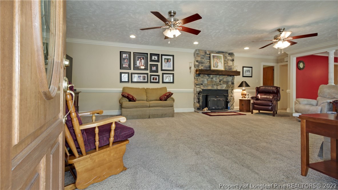 6250 Smithfield Road Wade, NC 28395 - Photo 9 of 46 a living room with furniture and a fireplace