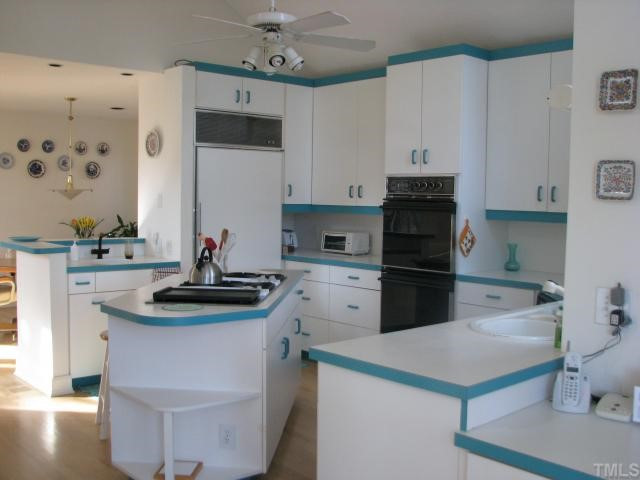 7301 Still Pond Court Raleigh, NC 27613 - Photo 8 of 12 Subzero refrigerator, Jennaire gas cooktop, double ovens, you will love cooking in this spacious kitchen (with 2 sinks!) Kitchen