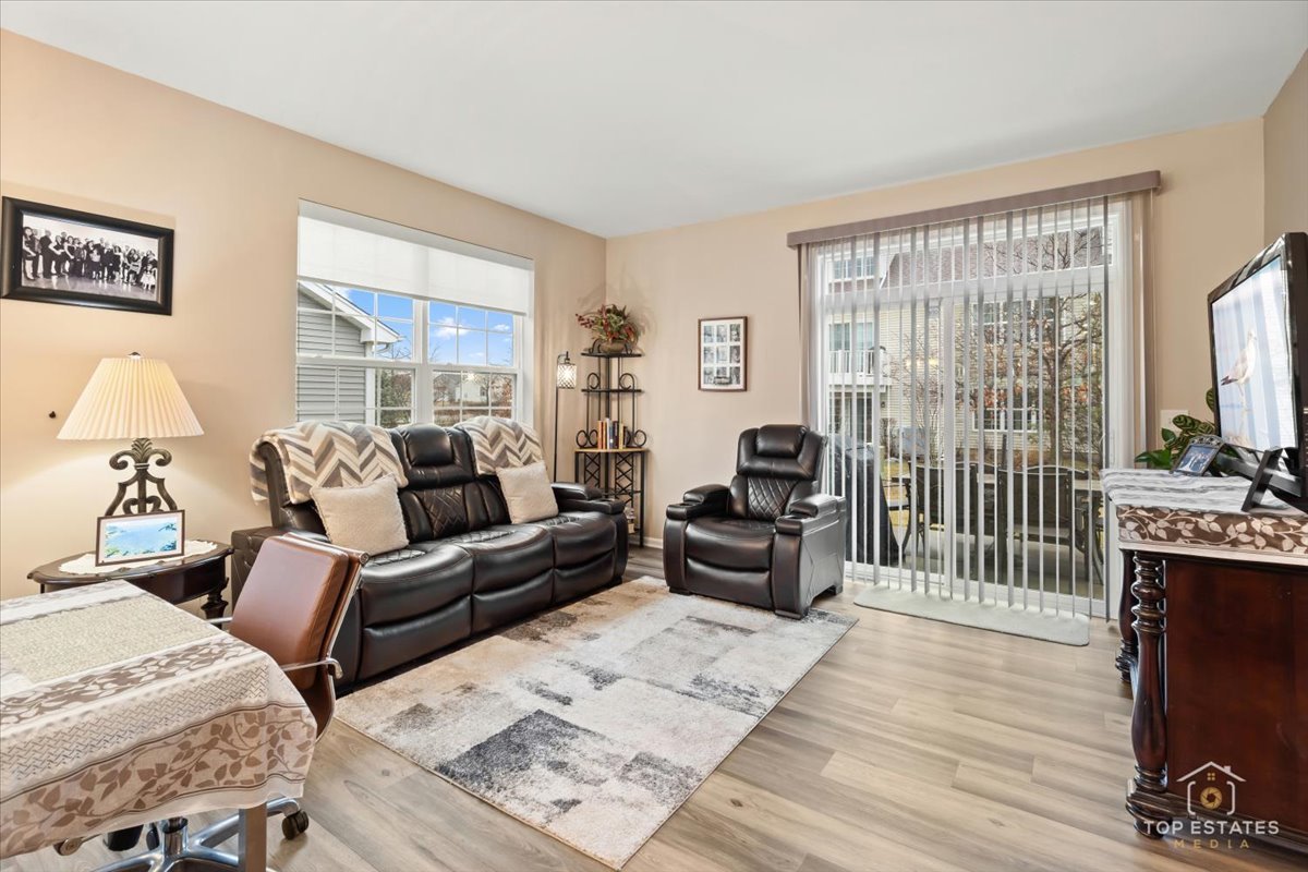 2010 Azure Lane Algonquin, IL 60102 - Photo 19 of 41 a living room with furniture a large window and a flat screen tv