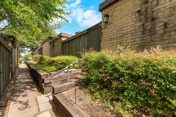 a backyard of a house with table and chairs