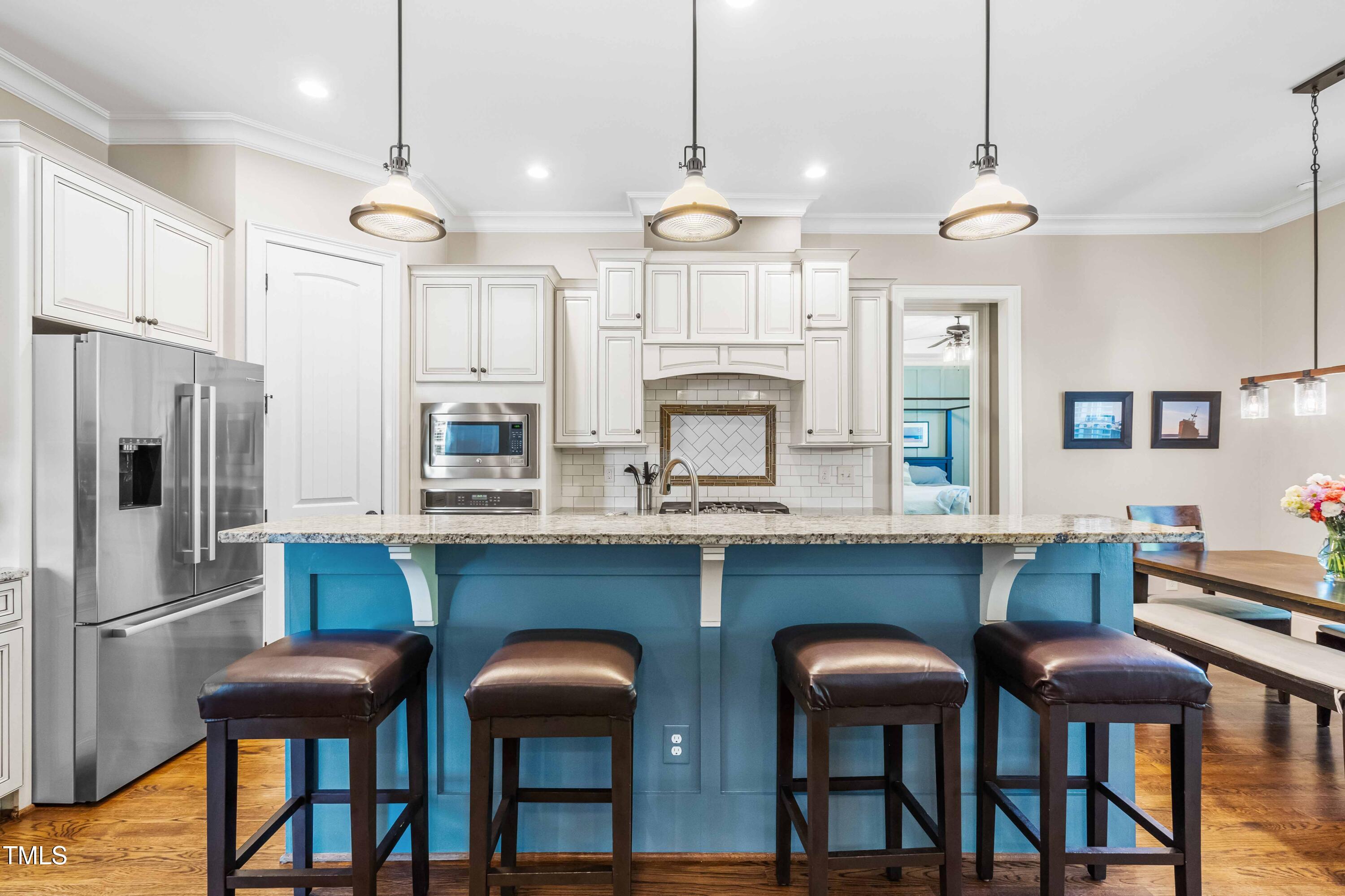 2538 Tuffeto Apex, NC 27502 - Photo 13 of 55 a kitchen with cabinets and chairs