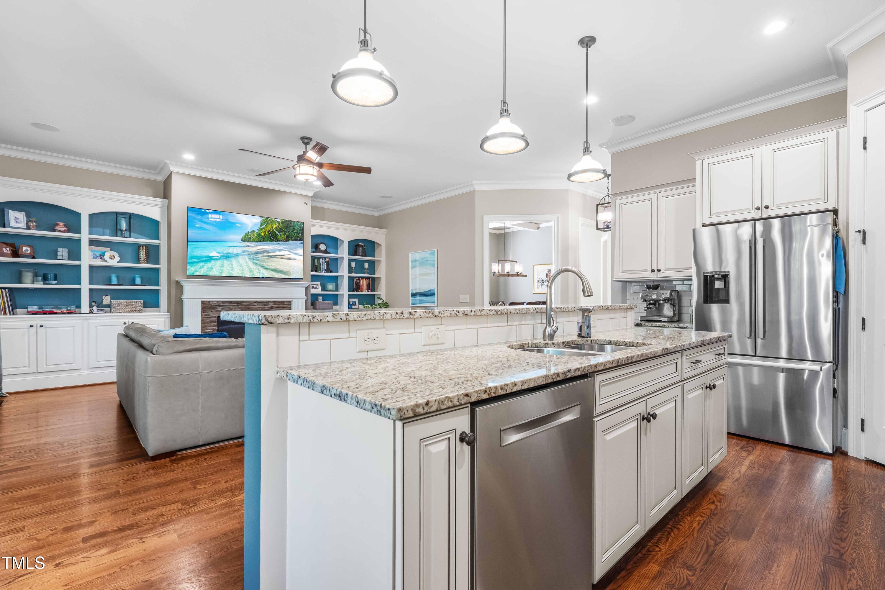 2538 Tuffeto Apex, NC 27502 - Photo 15 of 55 a kitchen with stainless steel appliances granite countertop a sink a stove and a wooden floors