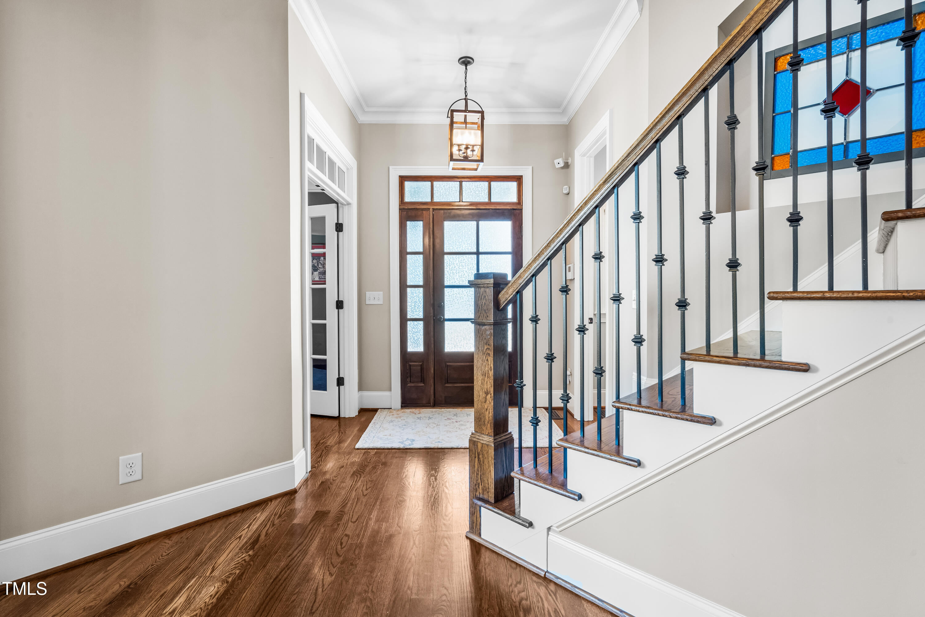 2538 Tuffeto Apex, NC 27502 - Photo 23 of 55 a view of staircase with lots of frames on wall and wooden floor